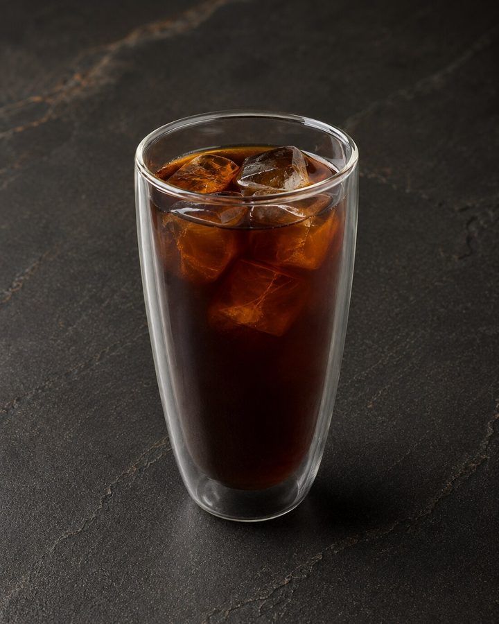 Iced americano in a tall glass at Nima Cafe, ready to take away